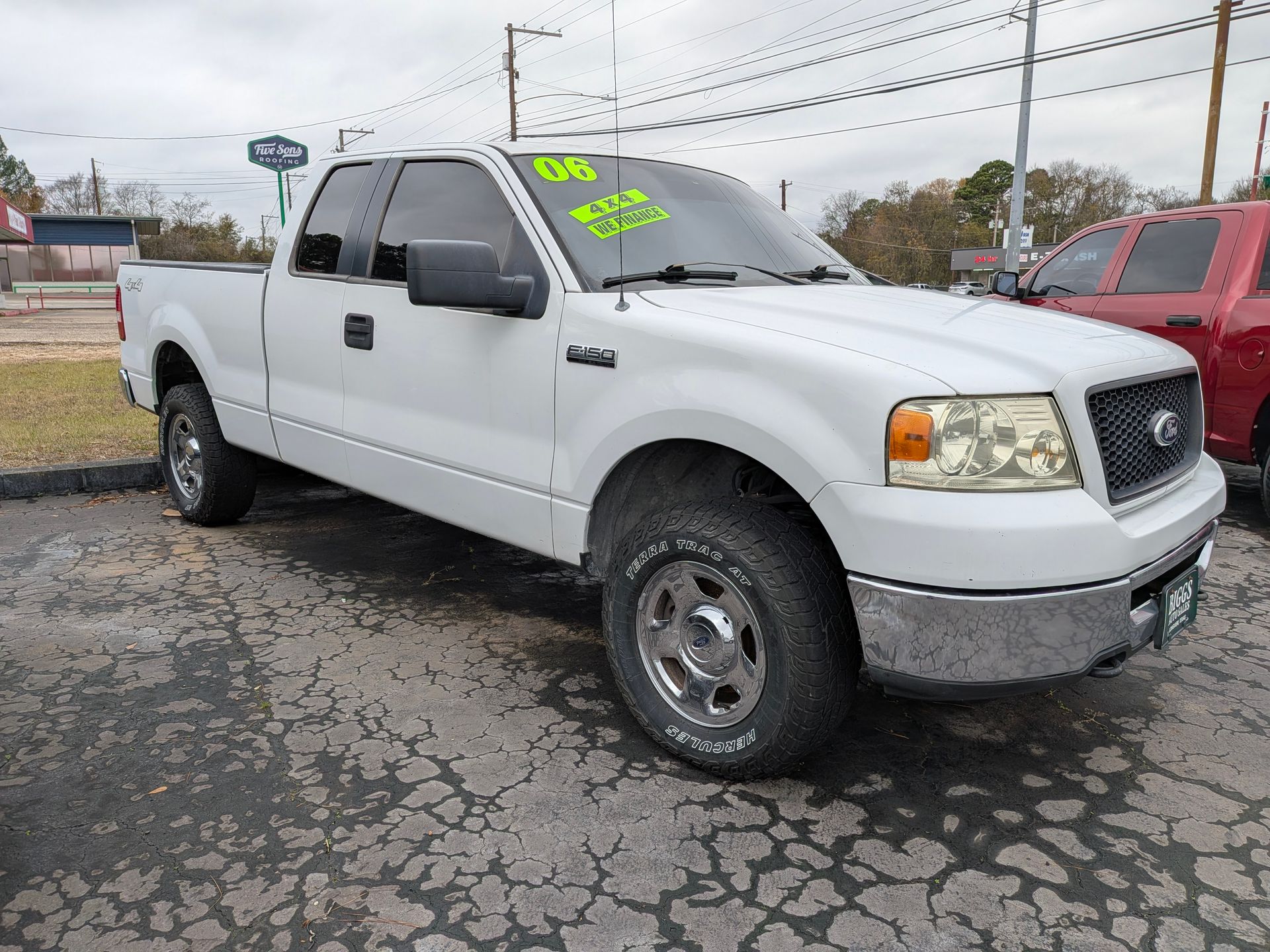 White Ford pickup truck parked on asphalt.