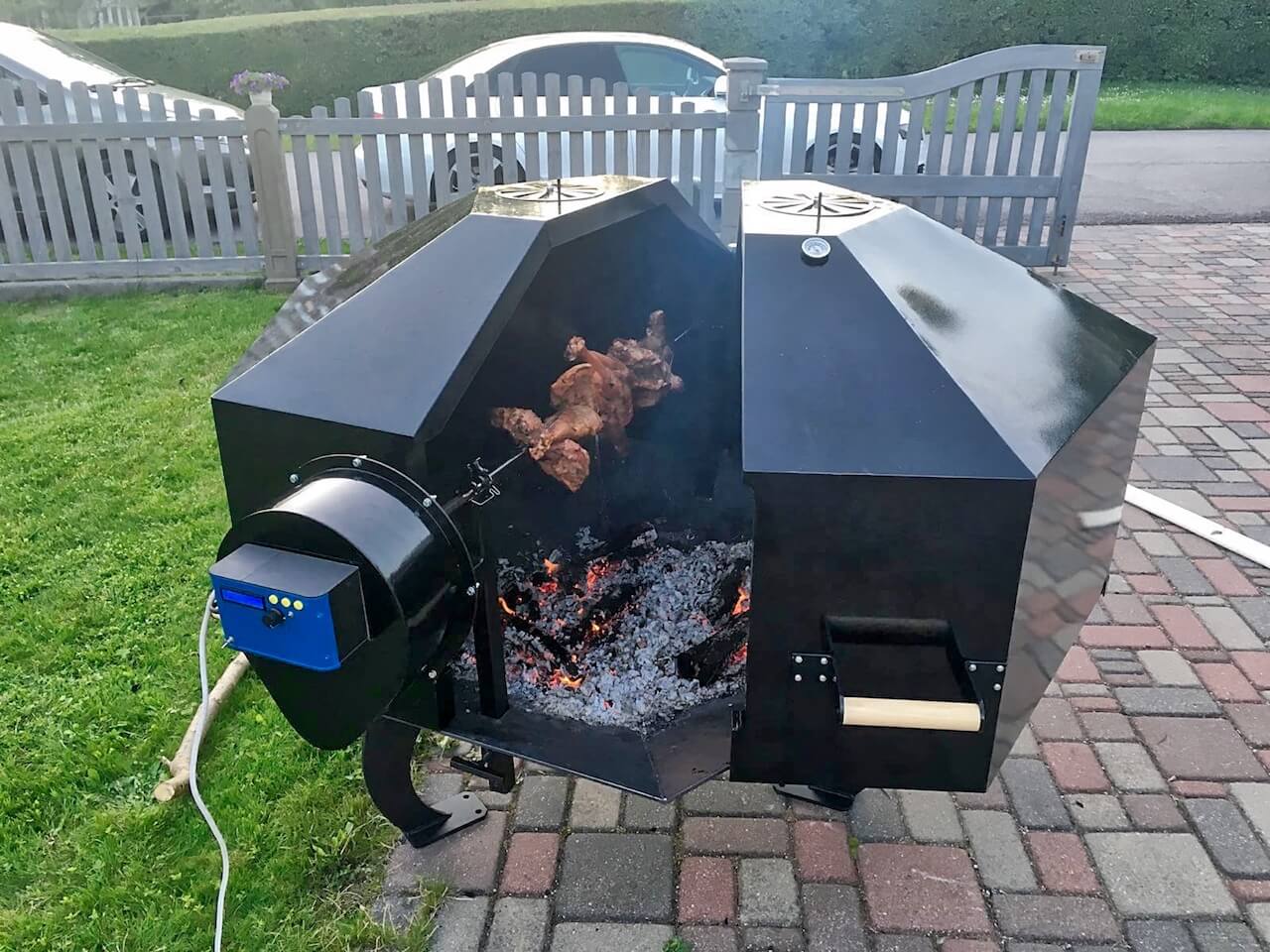 A pig is being cooked on a grill outside