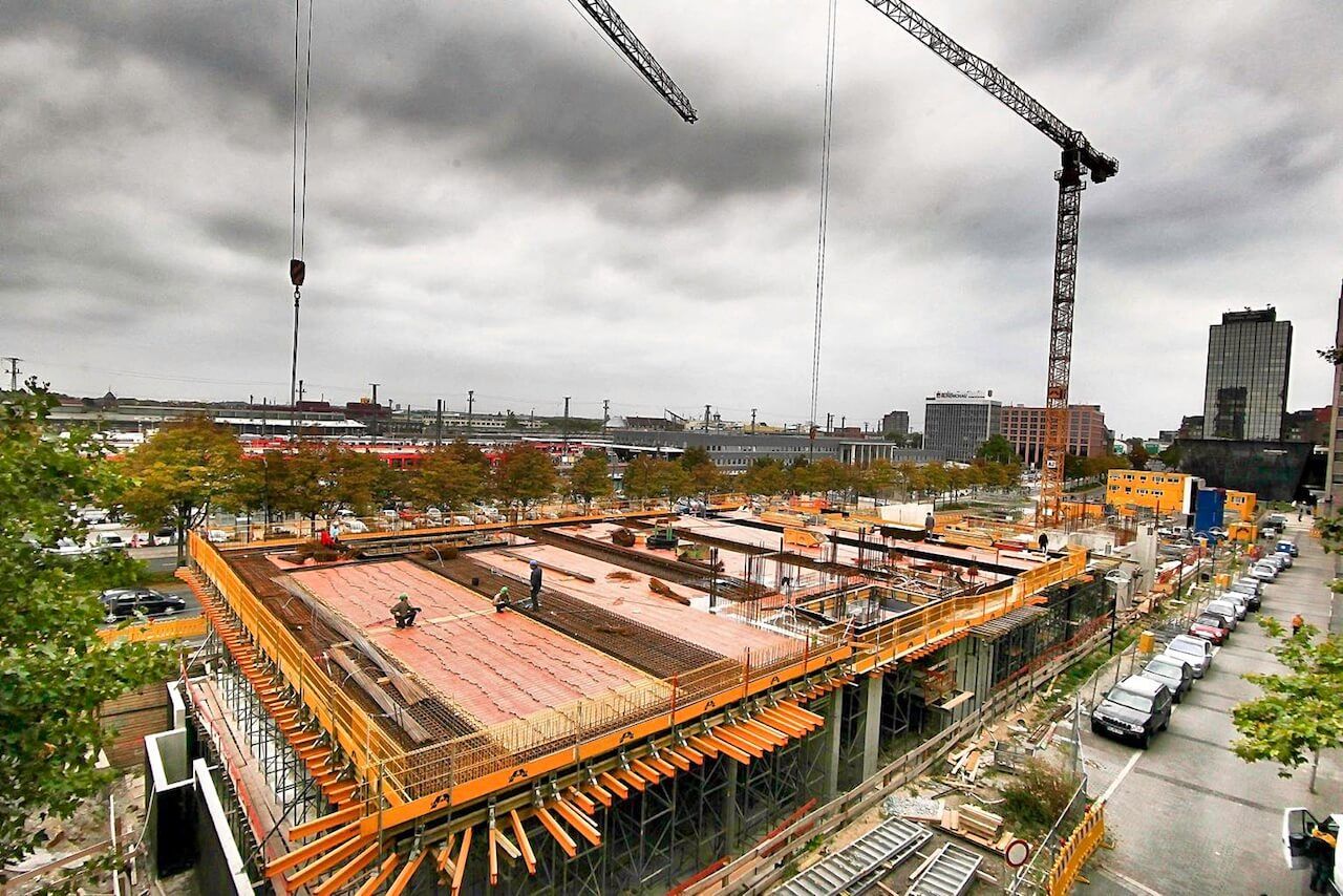 An aerial view of a construction site with a crane in the background.