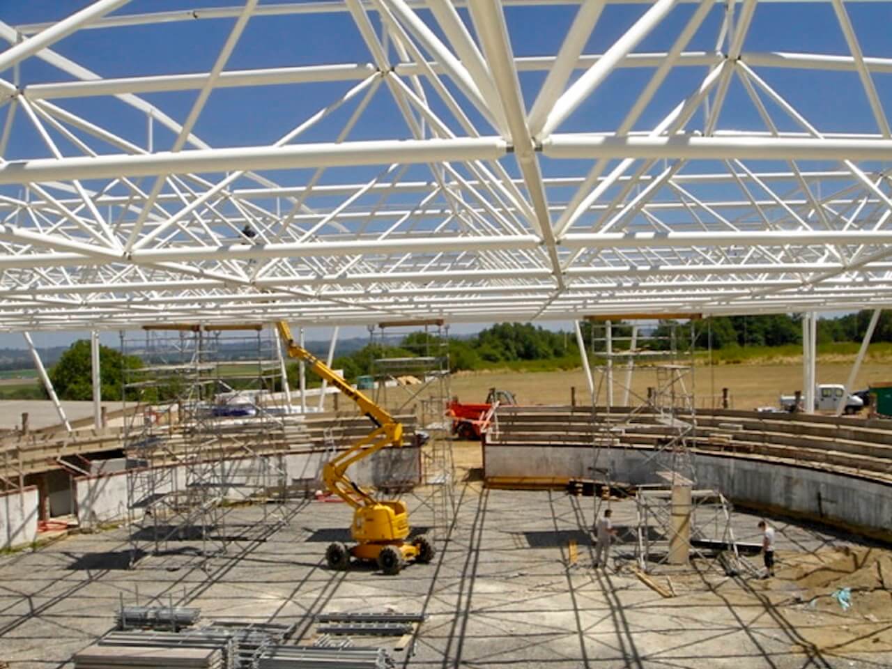 A construction site with a yellow crane in the foreground