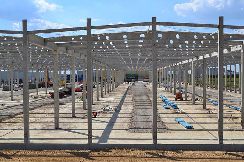 A large building under construction with a lot of steel beams.