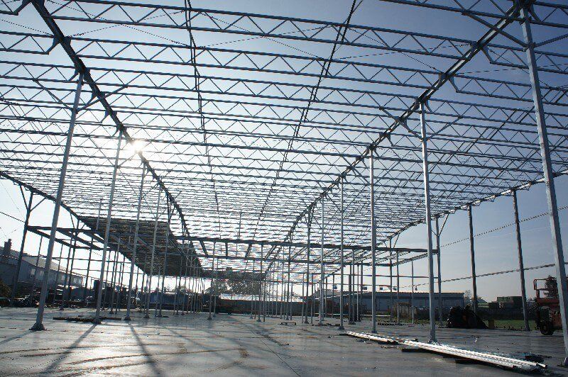The sun is shining through the roof of a building under construction