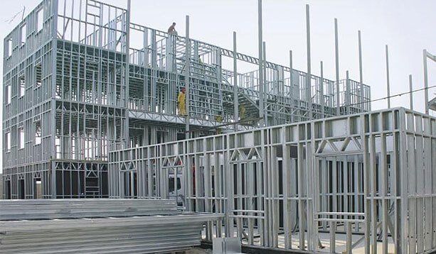 A large building under construction with a lot of metal frames.