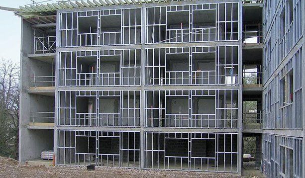 A large building under construction with a lot of windows and balconies.