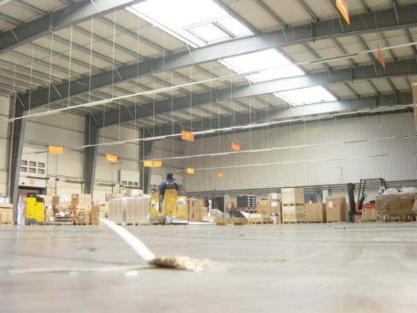 A warehouse with a lot of boxes on the floor