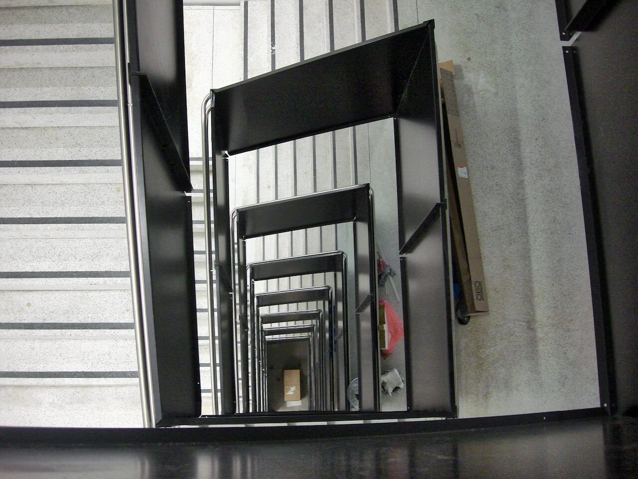 Looking down a set of stairs with a black railing