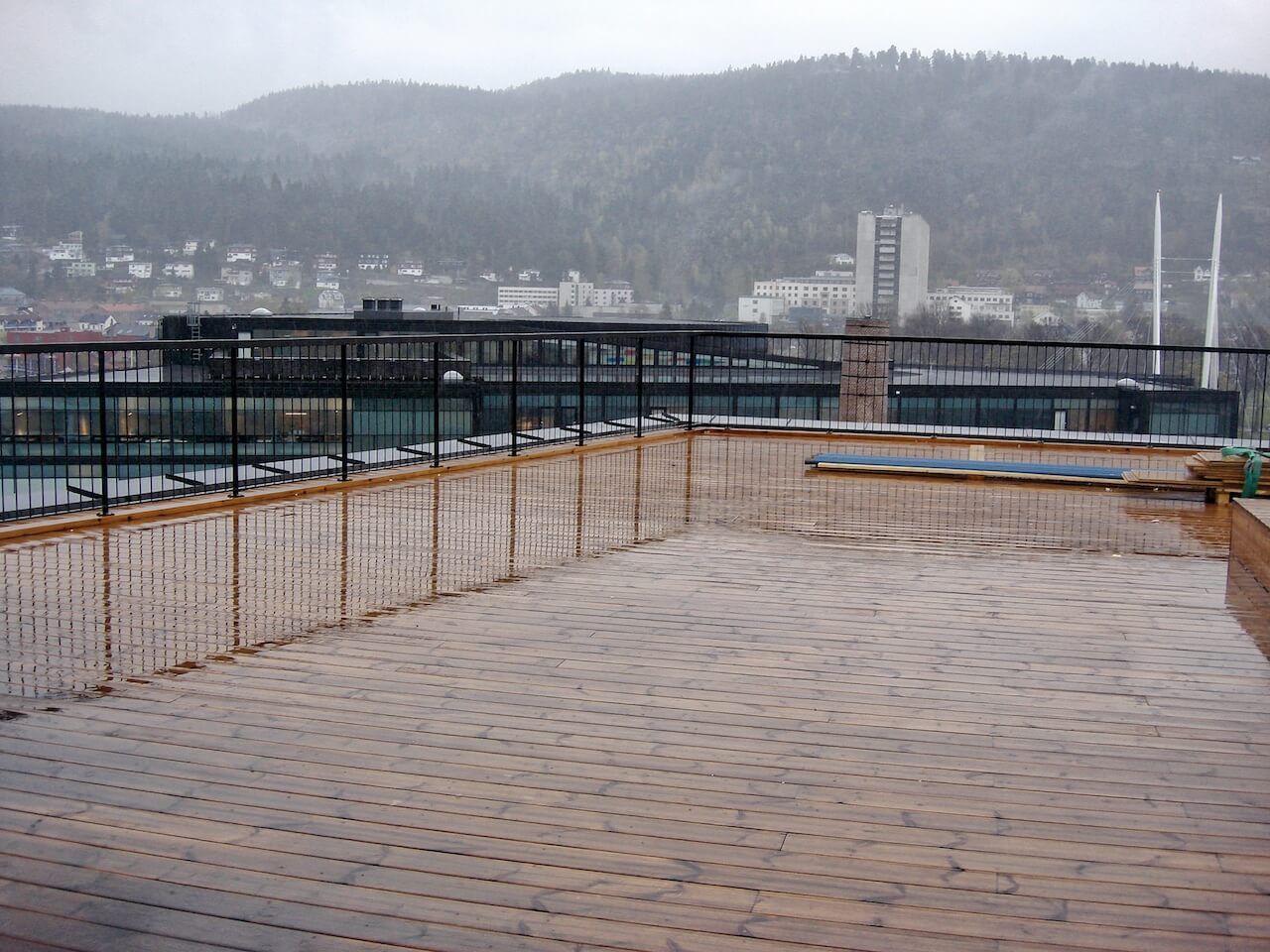 A bridge over a body of water with mountains in the background