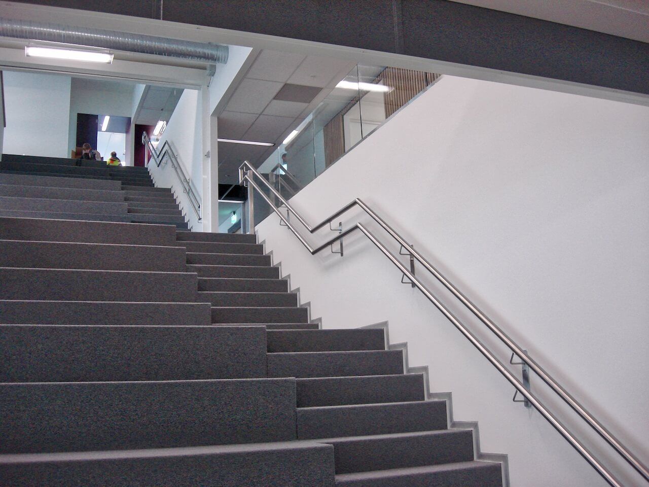 A set of stairs with a stainless steel railing