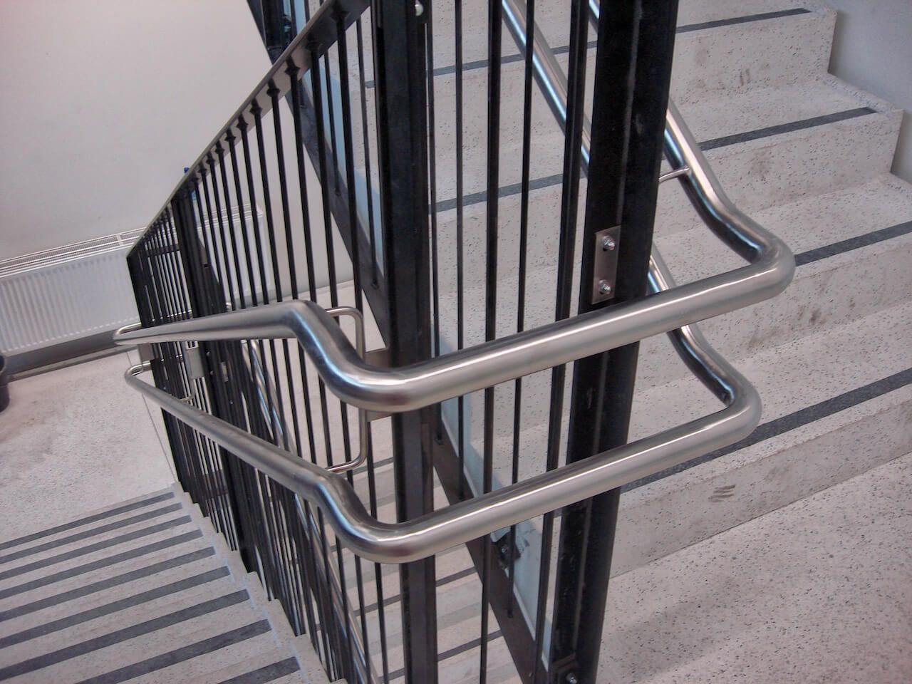 A close up of a metal railing on a set of stairs