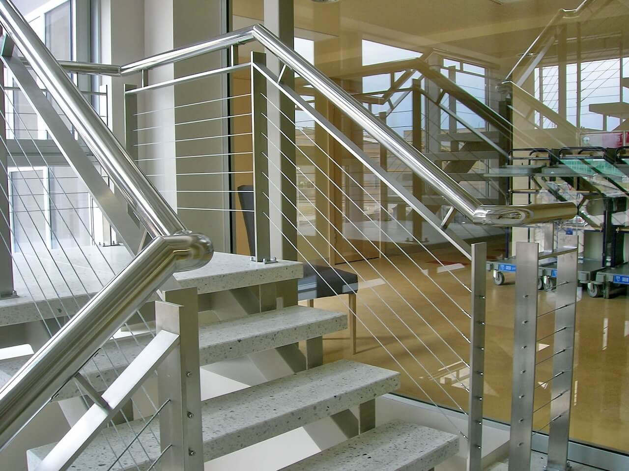 A set of stairs with a stainless steel railing