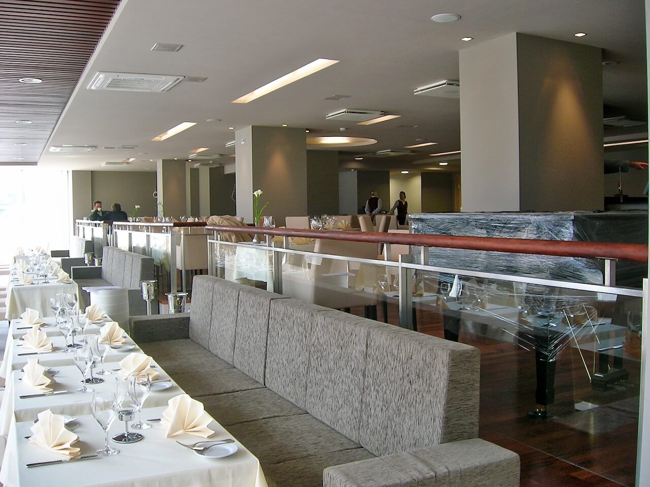 A restaurant with tables and chairs set up for dinner