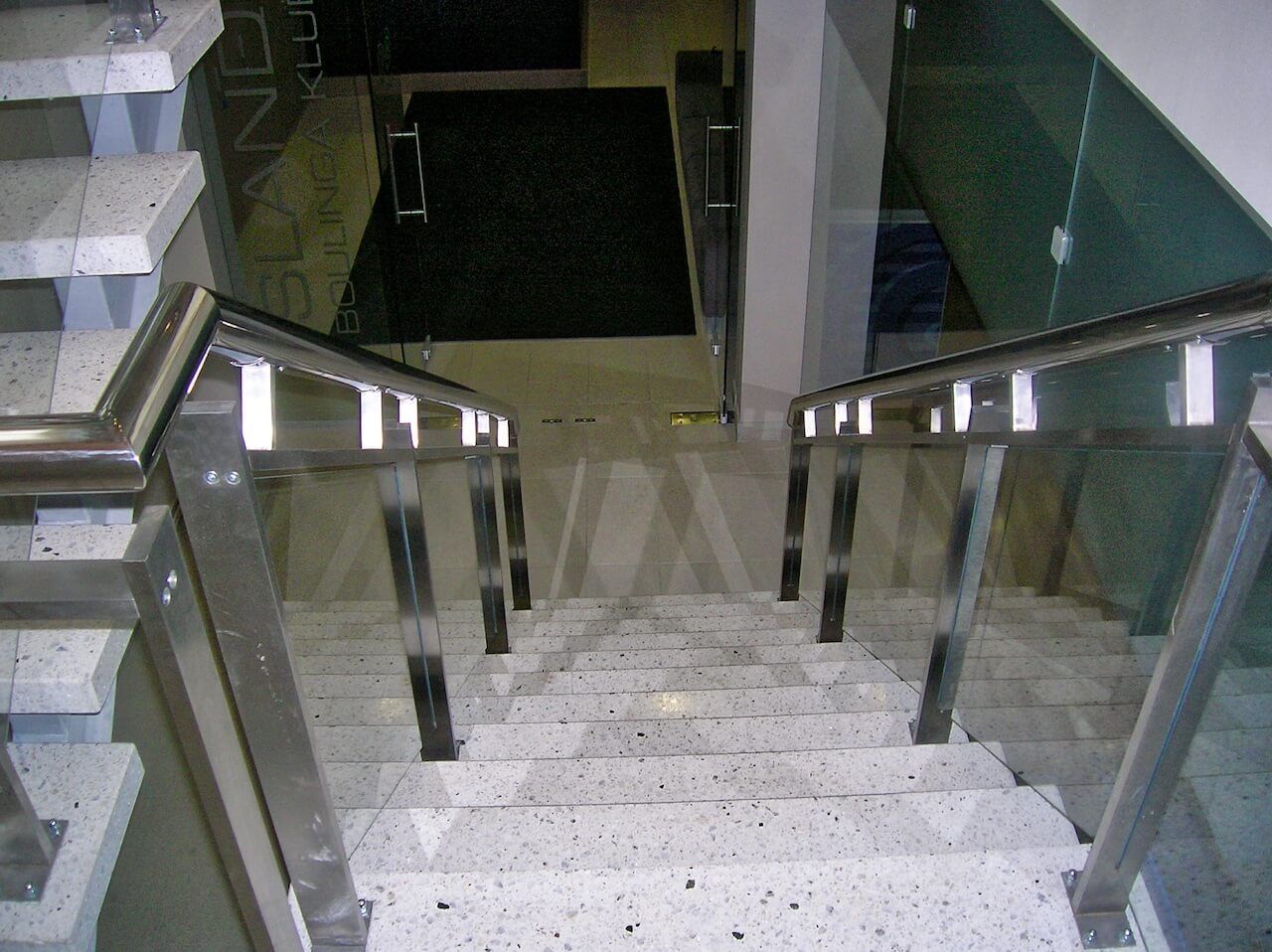 A set of stairs with a stainless steel railing