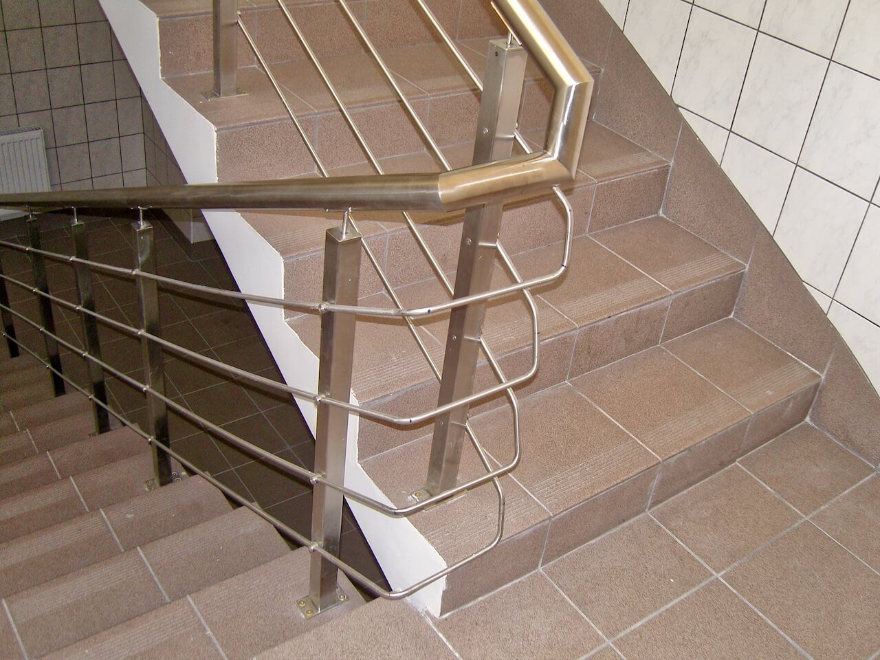 A set of stairs with a stainless steel railing