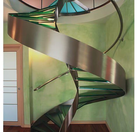 A spiral staircase made of stainless steel and glass