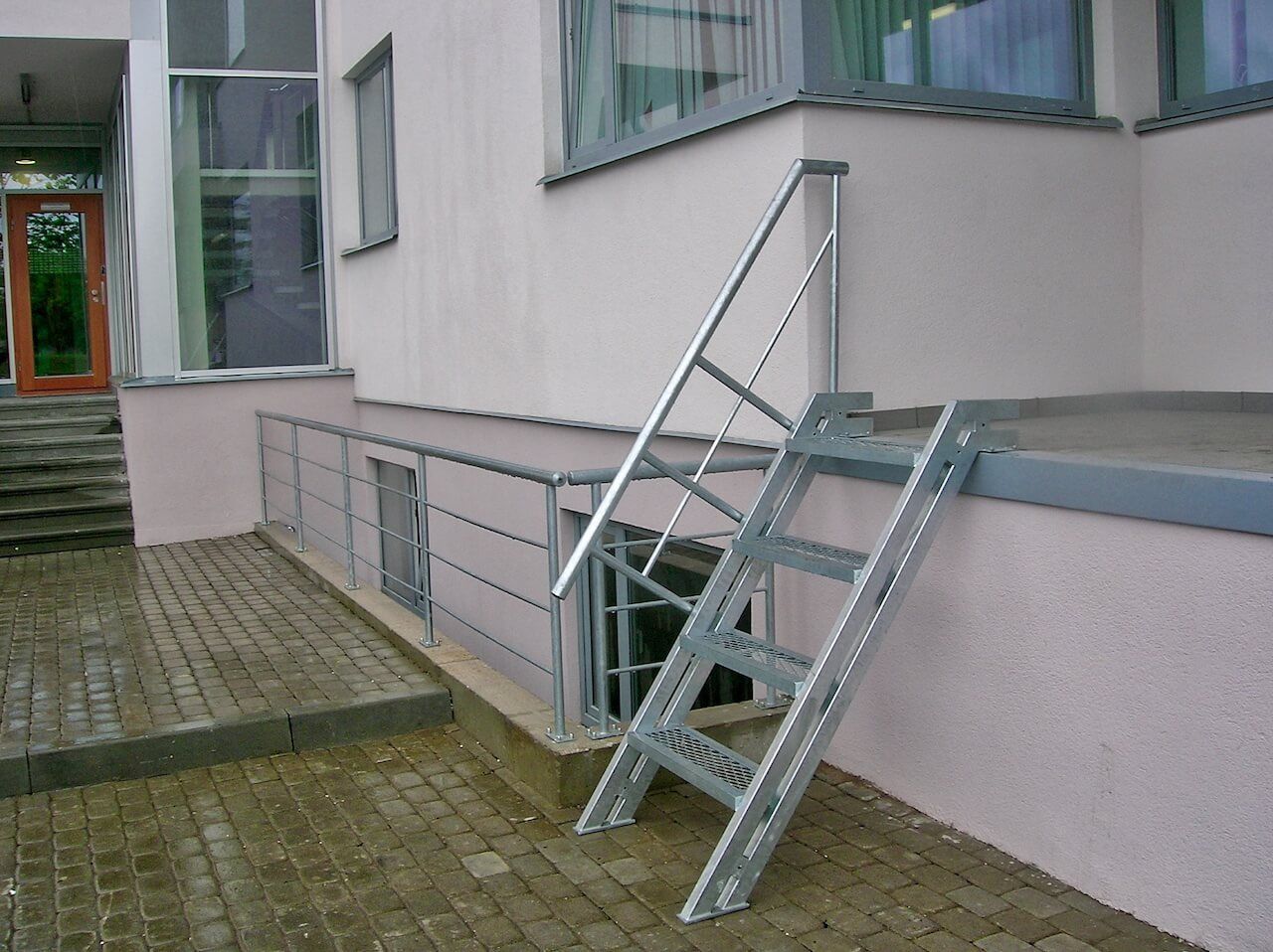 A set of metal stairs leading up to the side of a building