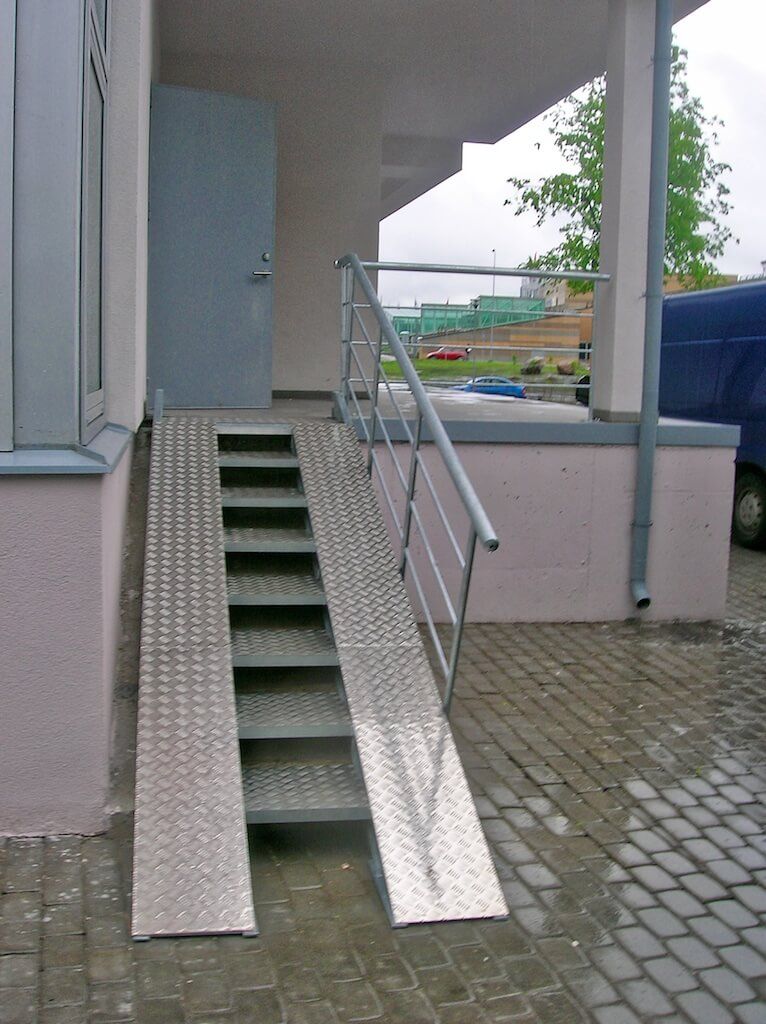 A staircase with a ramp leading up to it