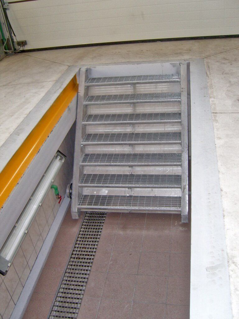 A set of metal stairs leading up to a garage