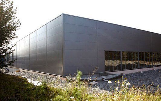 A large gray building with a lot of windows is being built.