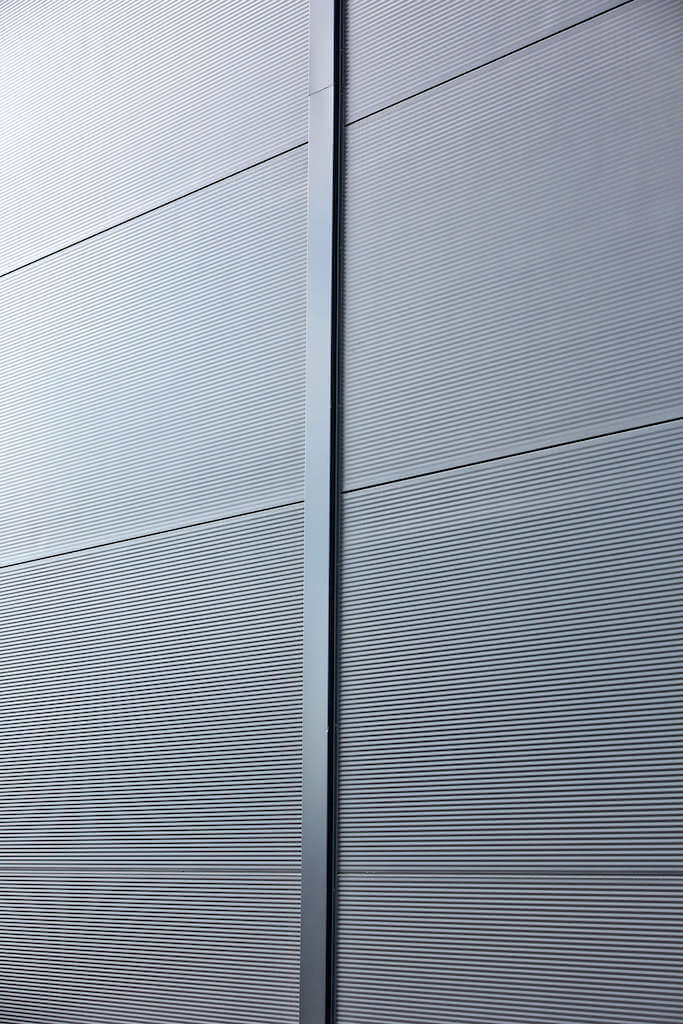 A close up of a metal wall with a striped pattern on it.