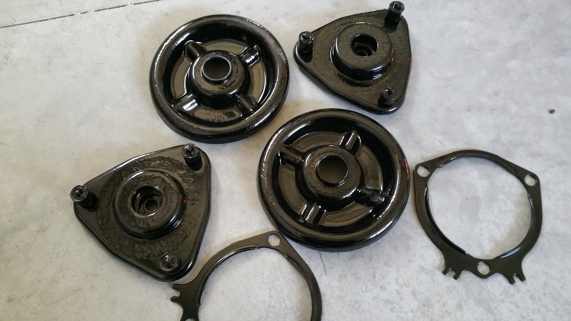 A bunch of black circles and rings on a white surface