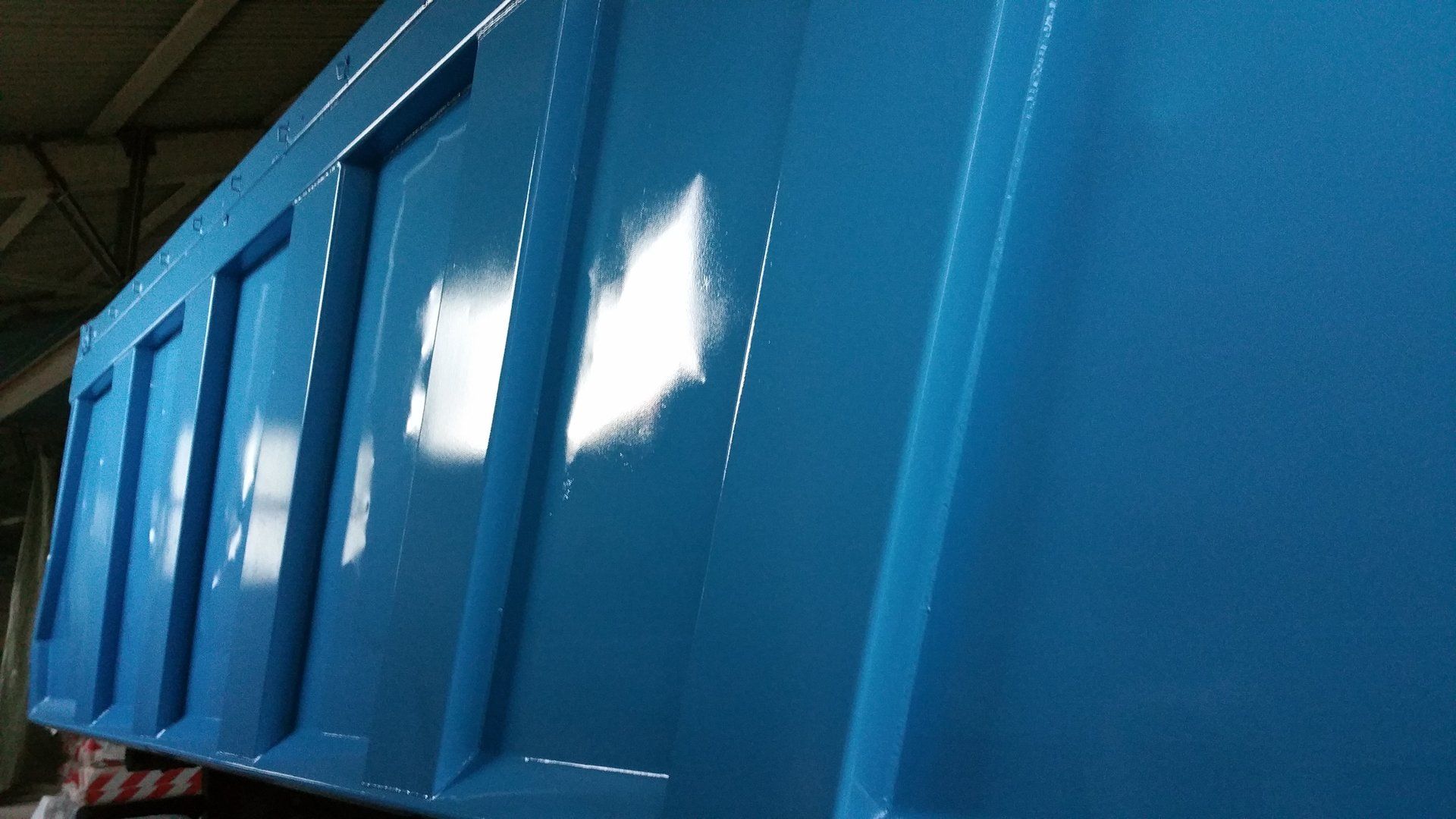 A blue container with a white triangle on the side