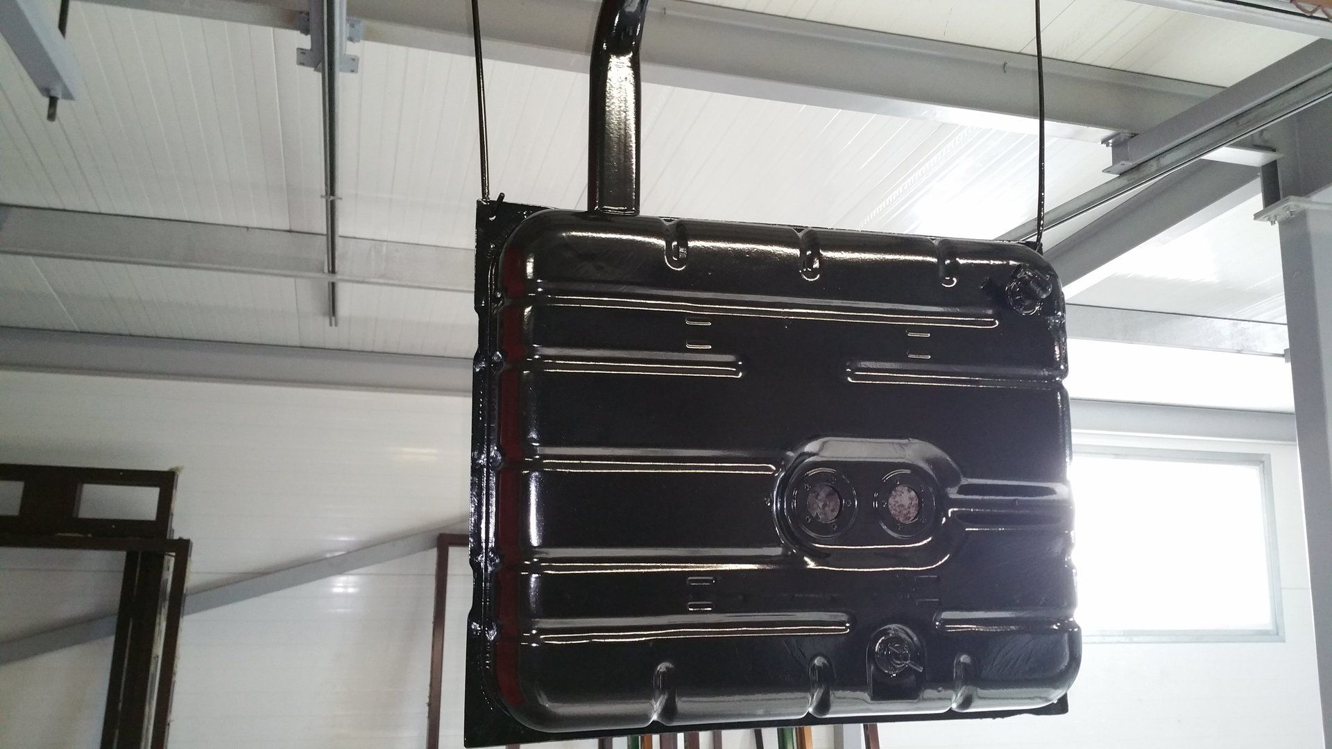 A large black metal object is hanging from the ceiling