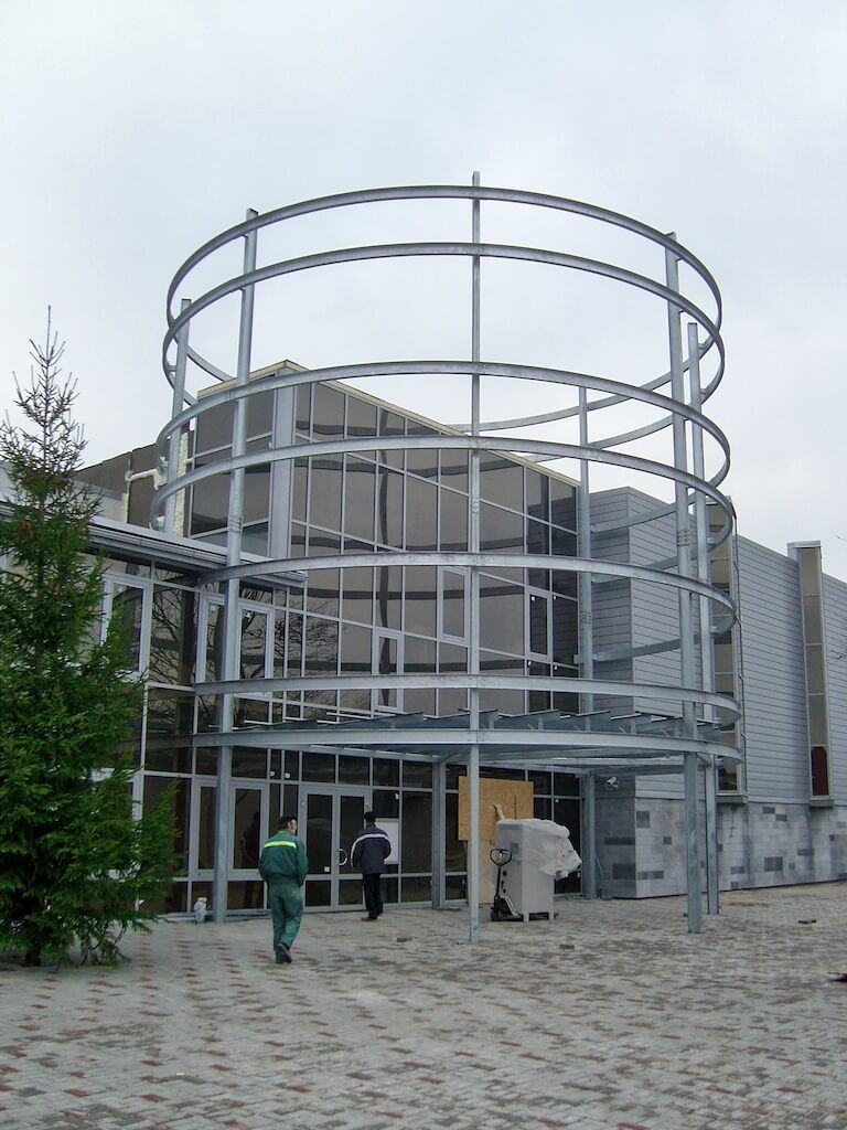 A large building with a circular structure in front of it