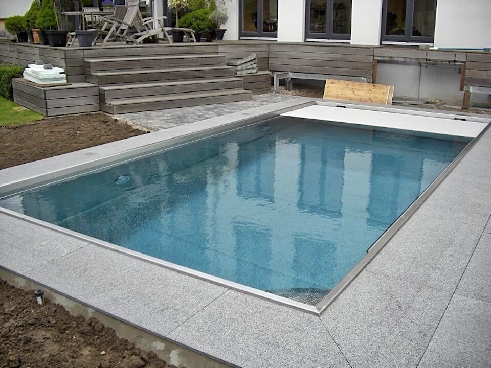 A stainless steel swimming pool with a white cover