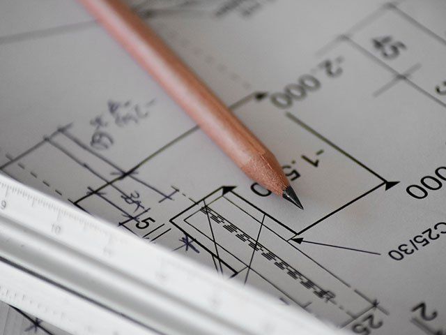 Image of a blueprint and a pencil