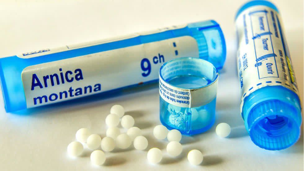 Empty vial next to small white balls