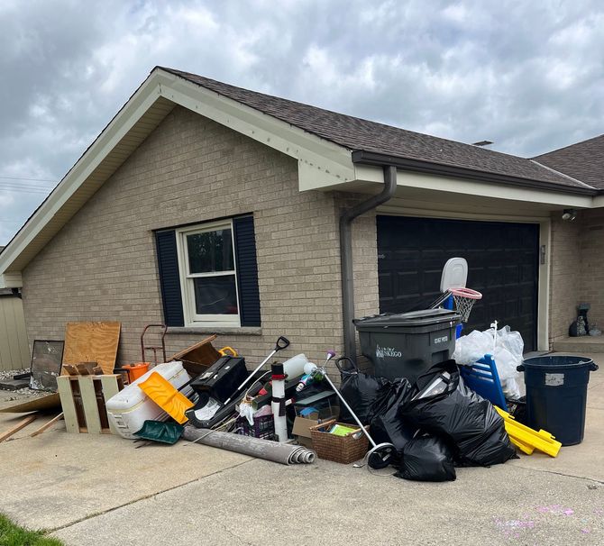 A house with a lot of trash in front of it