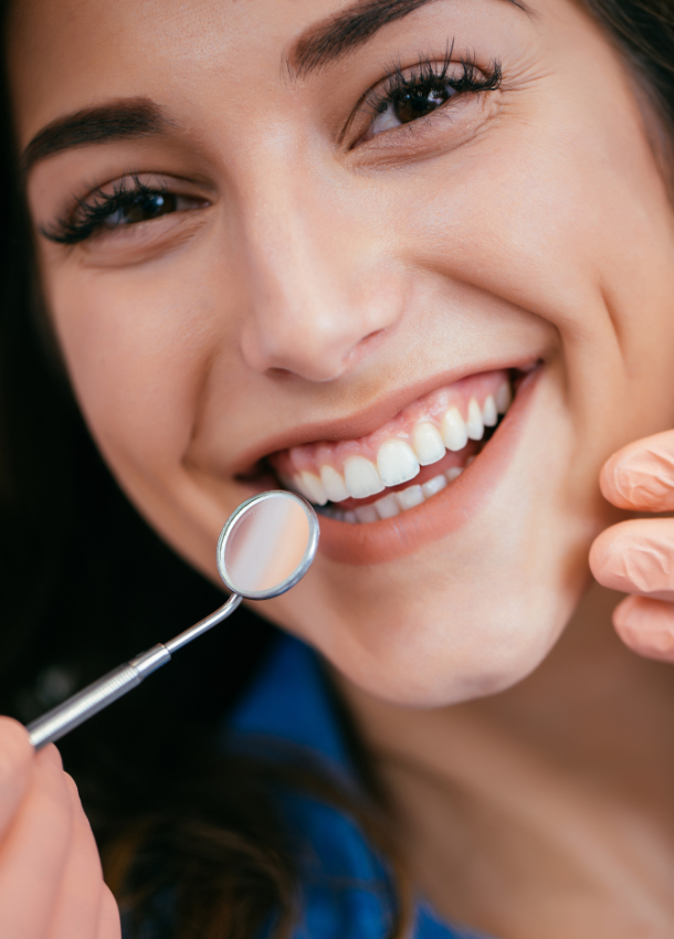 A woman is holding a clear brace in her hand.