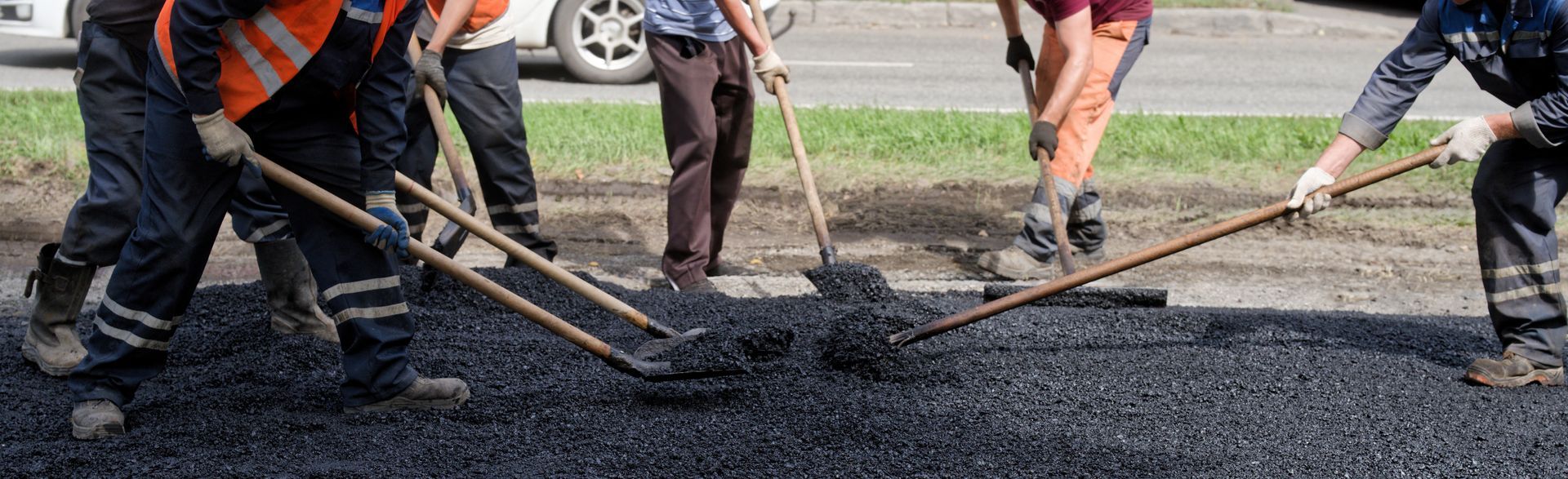 Road workers laying asphalt.
