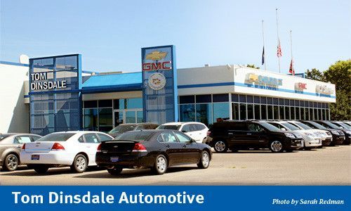 Tom Dinsdale Automotive dealership with cars for sale in front of the building.