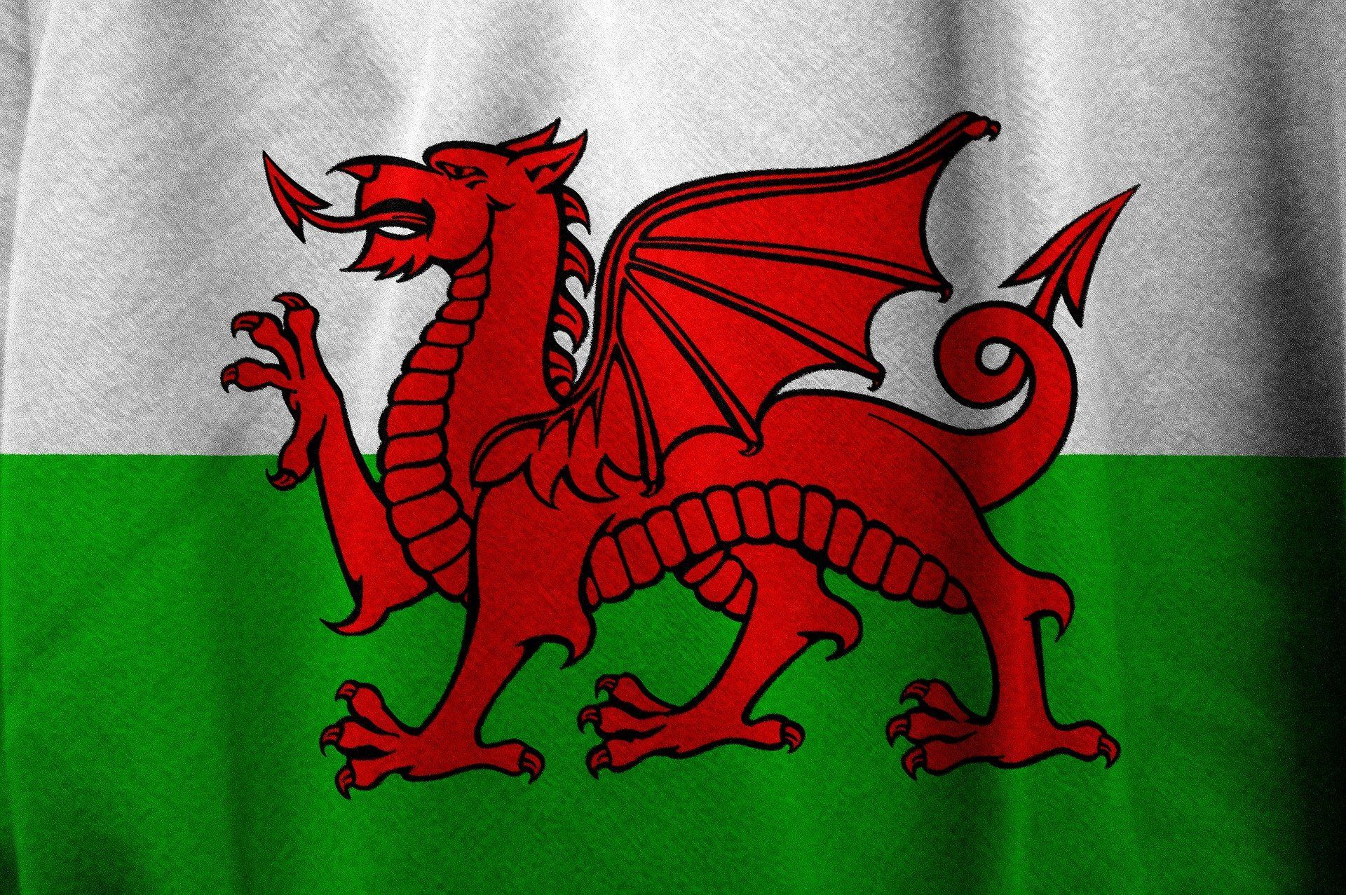 Flag of Wales: Red dragon on a white and green striped background.