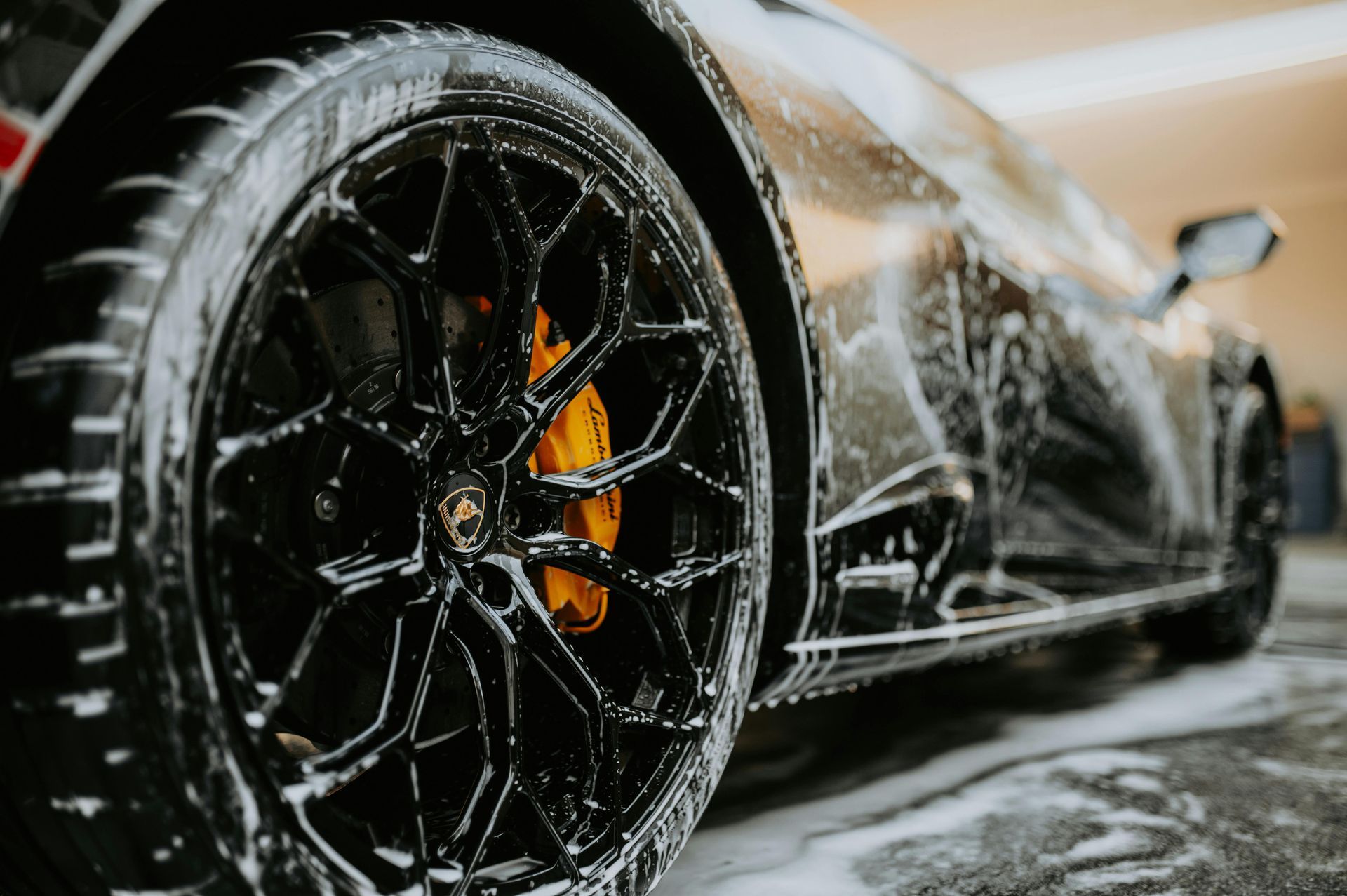 A close up of a car wheel covered in soap.