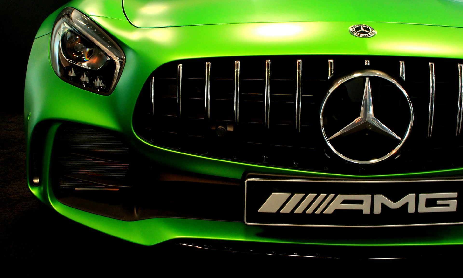 The front of a green mercedes amg sports car
