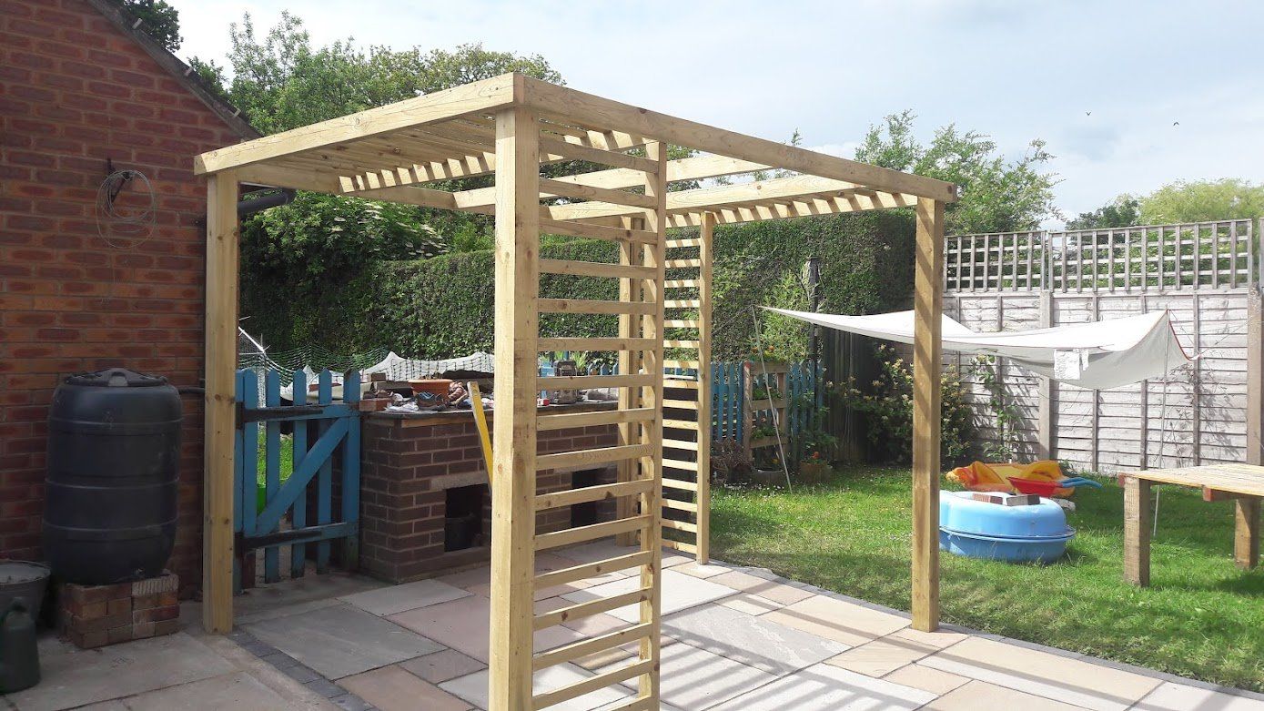 Pergola on top of paving and grass garden