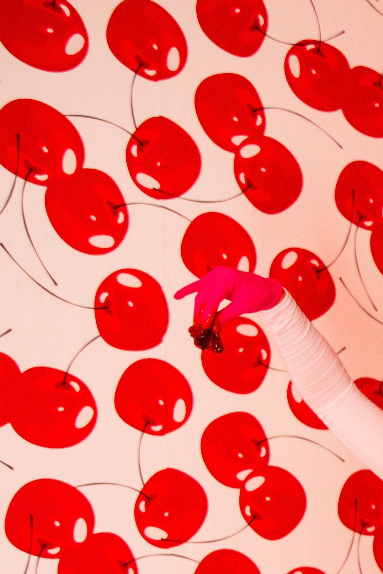 Hand gently touches thigh, showing stretch marks. White underwear, light background.