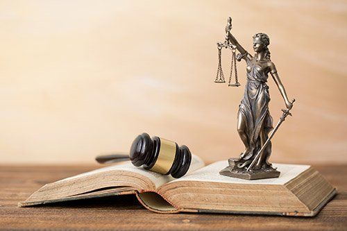 DWI Defense — Themis Statue and Gavel on Open Book in Massillon, OH