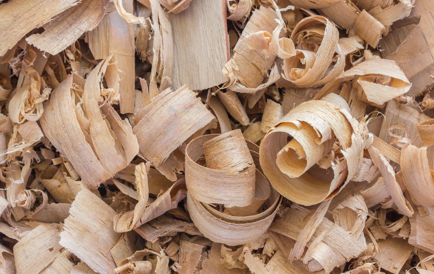 A pile of wood shavings on a table.