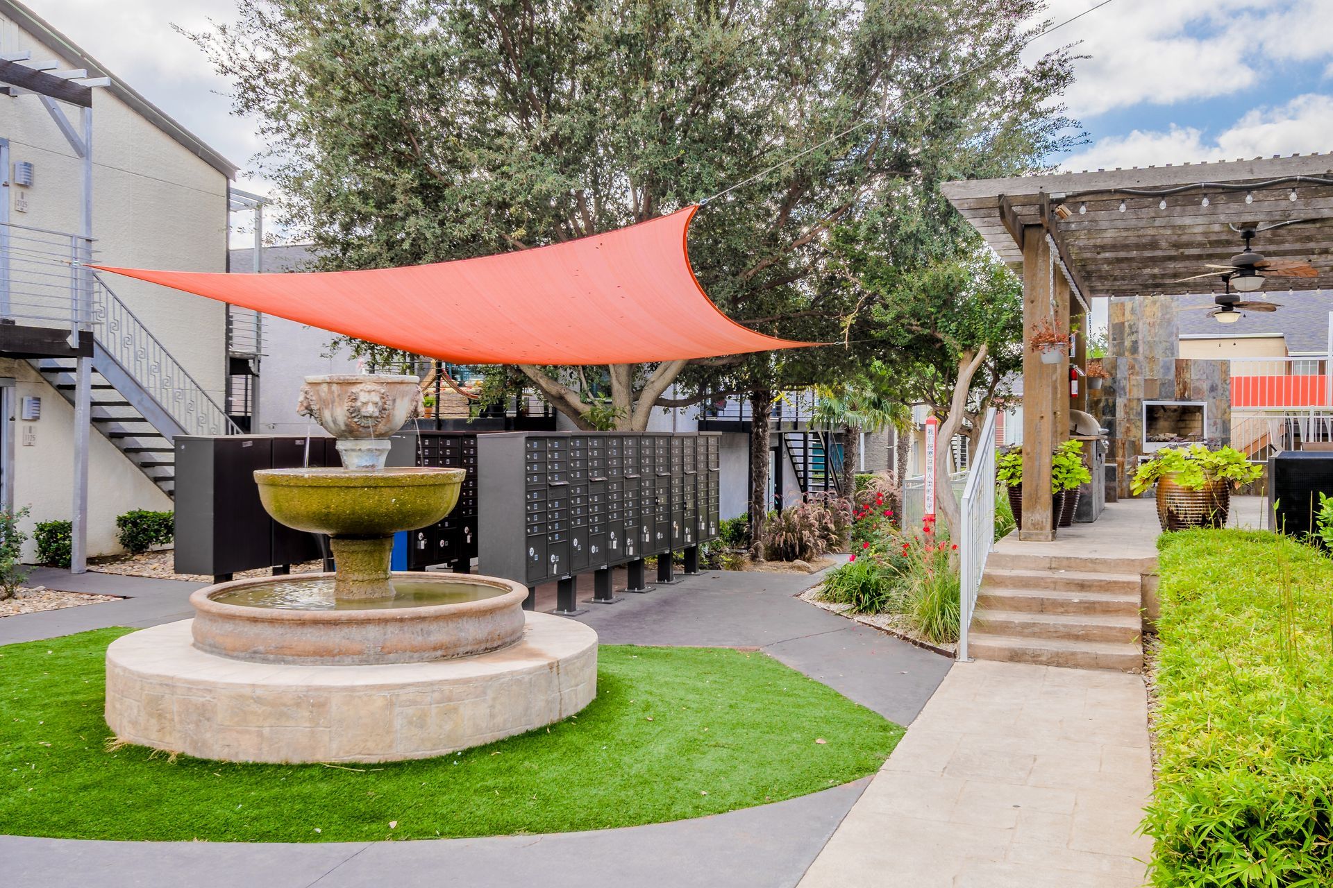 Photo of a fountain at the community, with mailboxes in the background