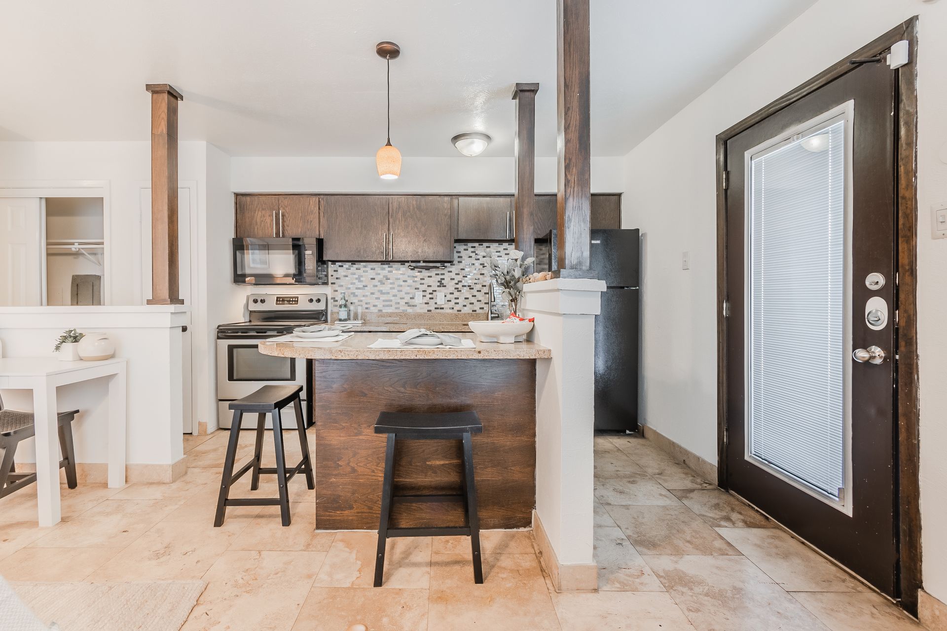 Photo of a dining area showing the kitchen in the background
