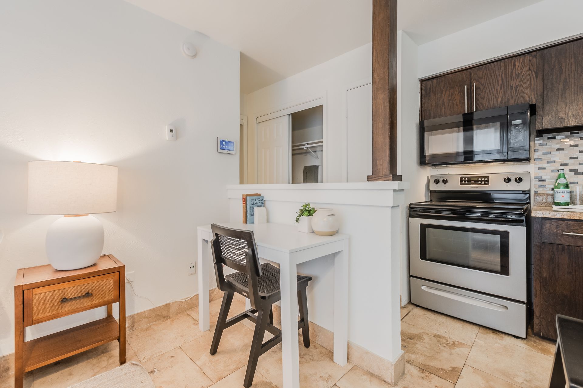 Photo of a small computer table set against a wall at the entrance to the kitchen