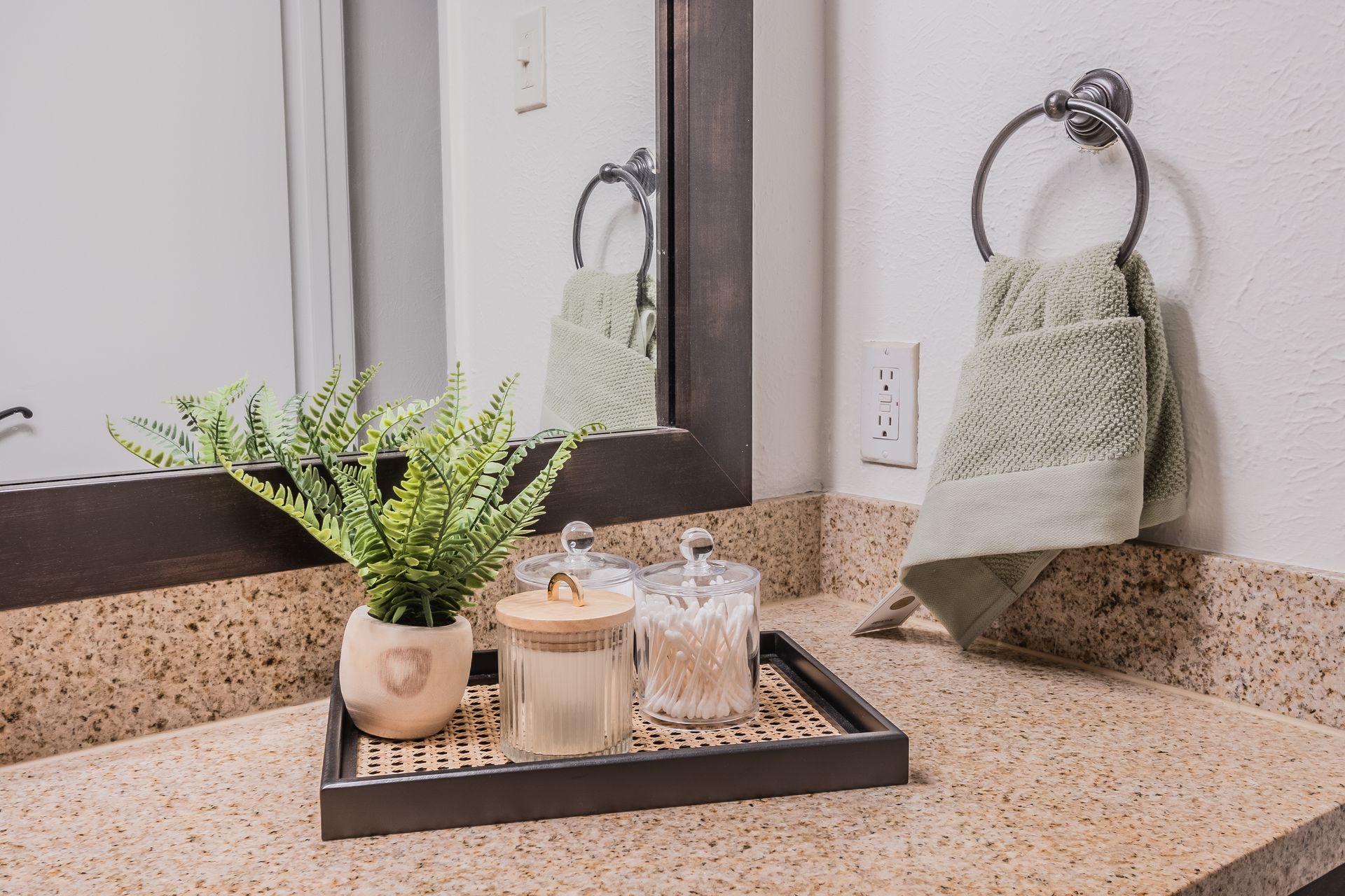 Photo of a few toiletries and pleasantries on a bathroom sink counter