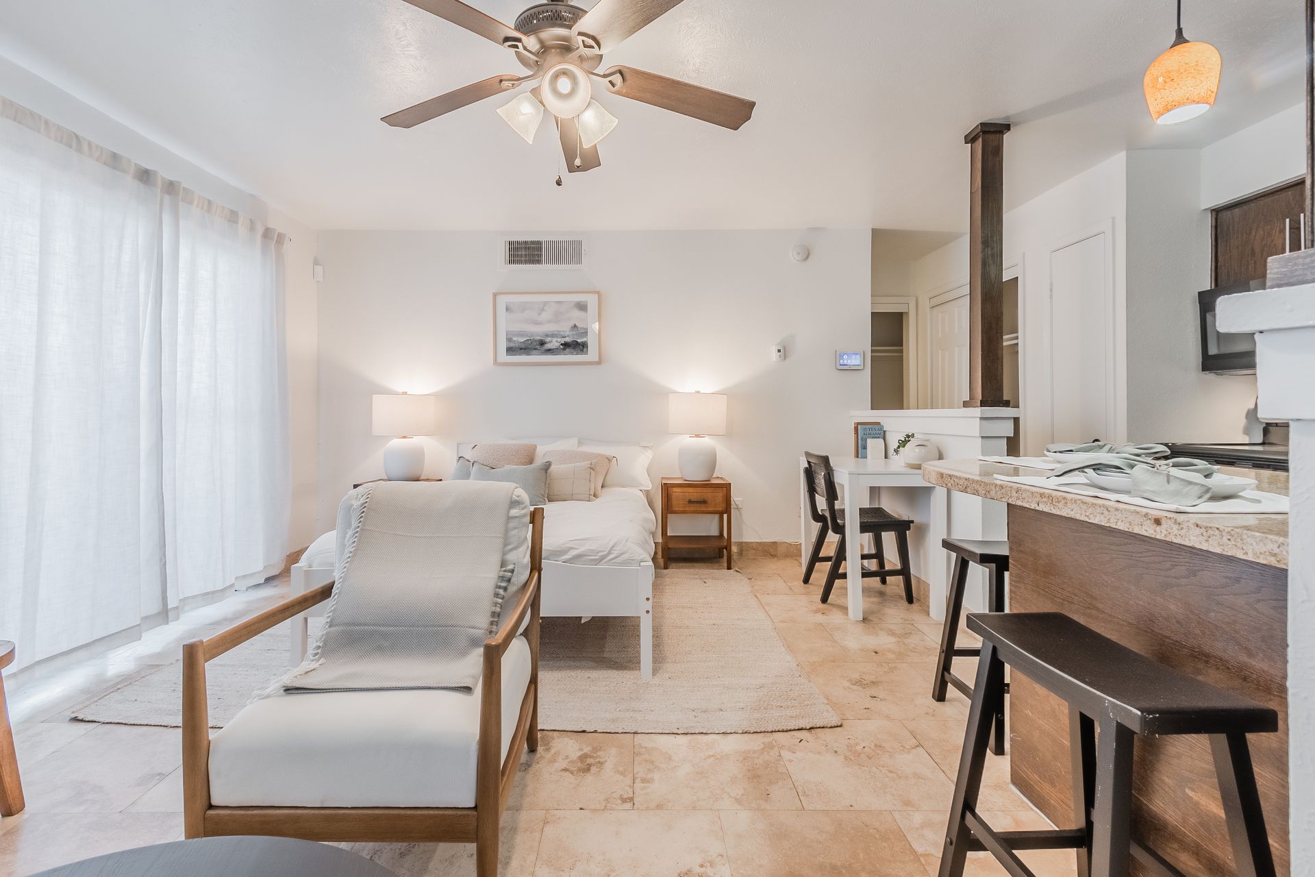 Photo showing the living room area with the bed in the background