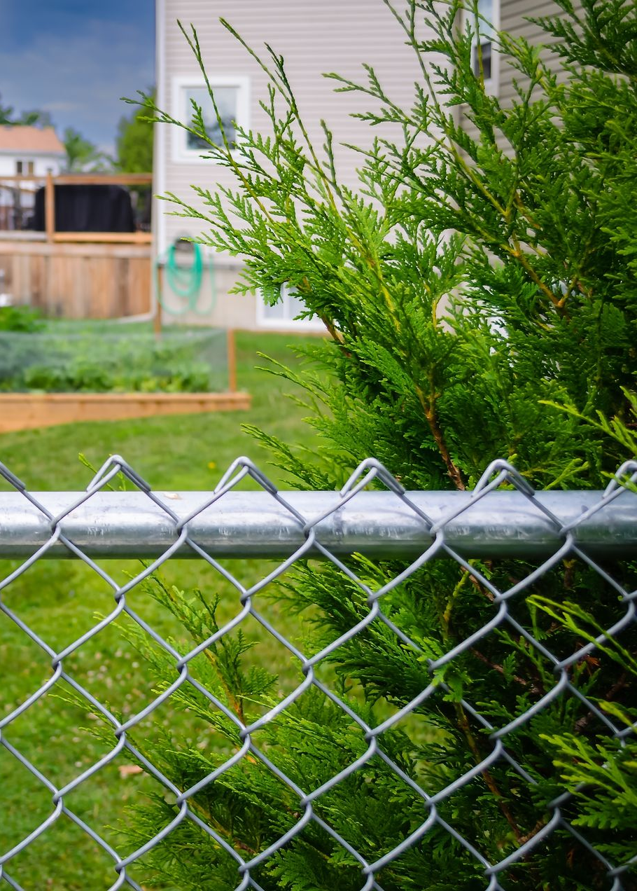 Chain link fence corner section, metallic gray.
