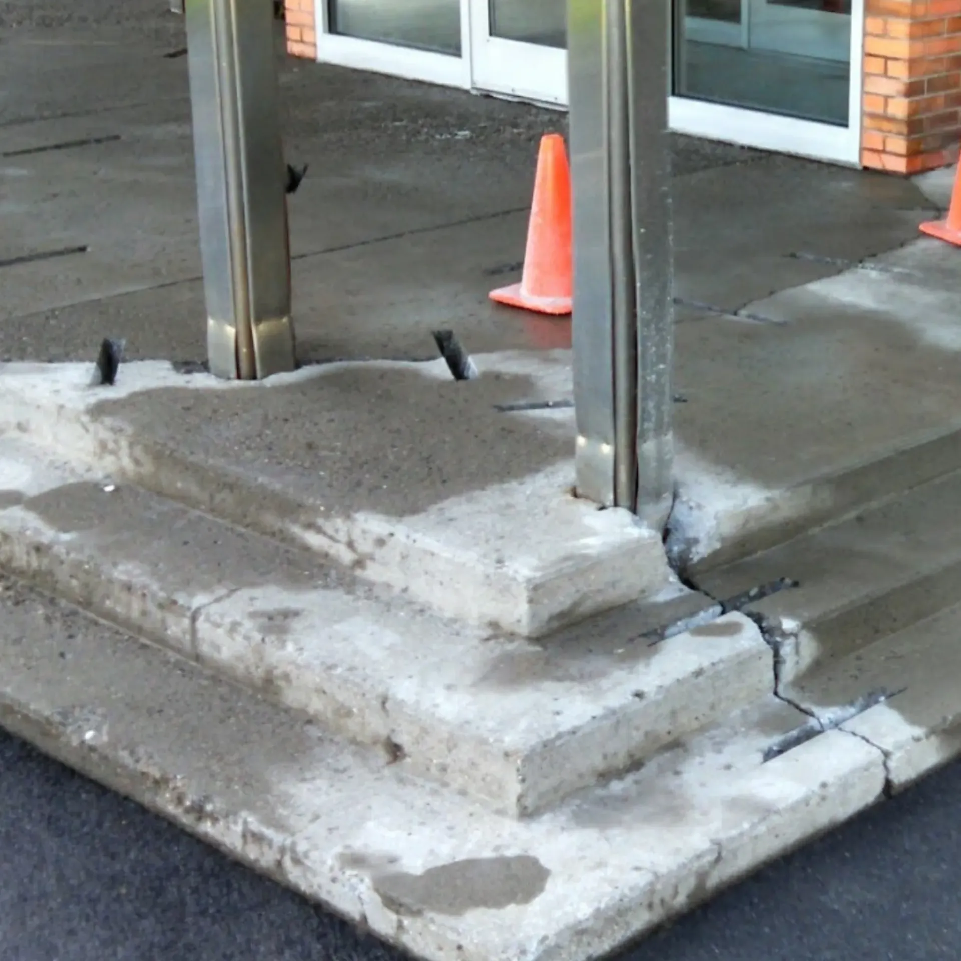 CK Maintenance LLC - A set of concrete steps with a brick building in the background