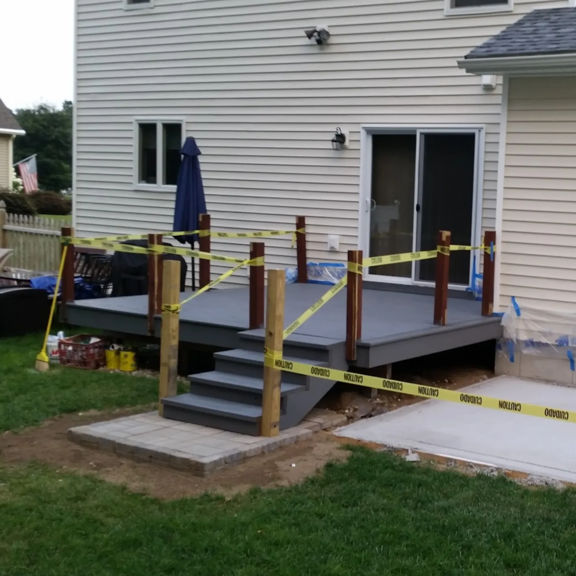 CK Maintenance LLC - A deck is being built in front of a white house