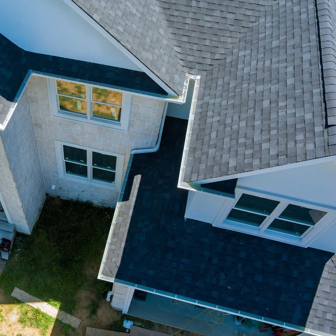 An aerial view of a house with a gray roof